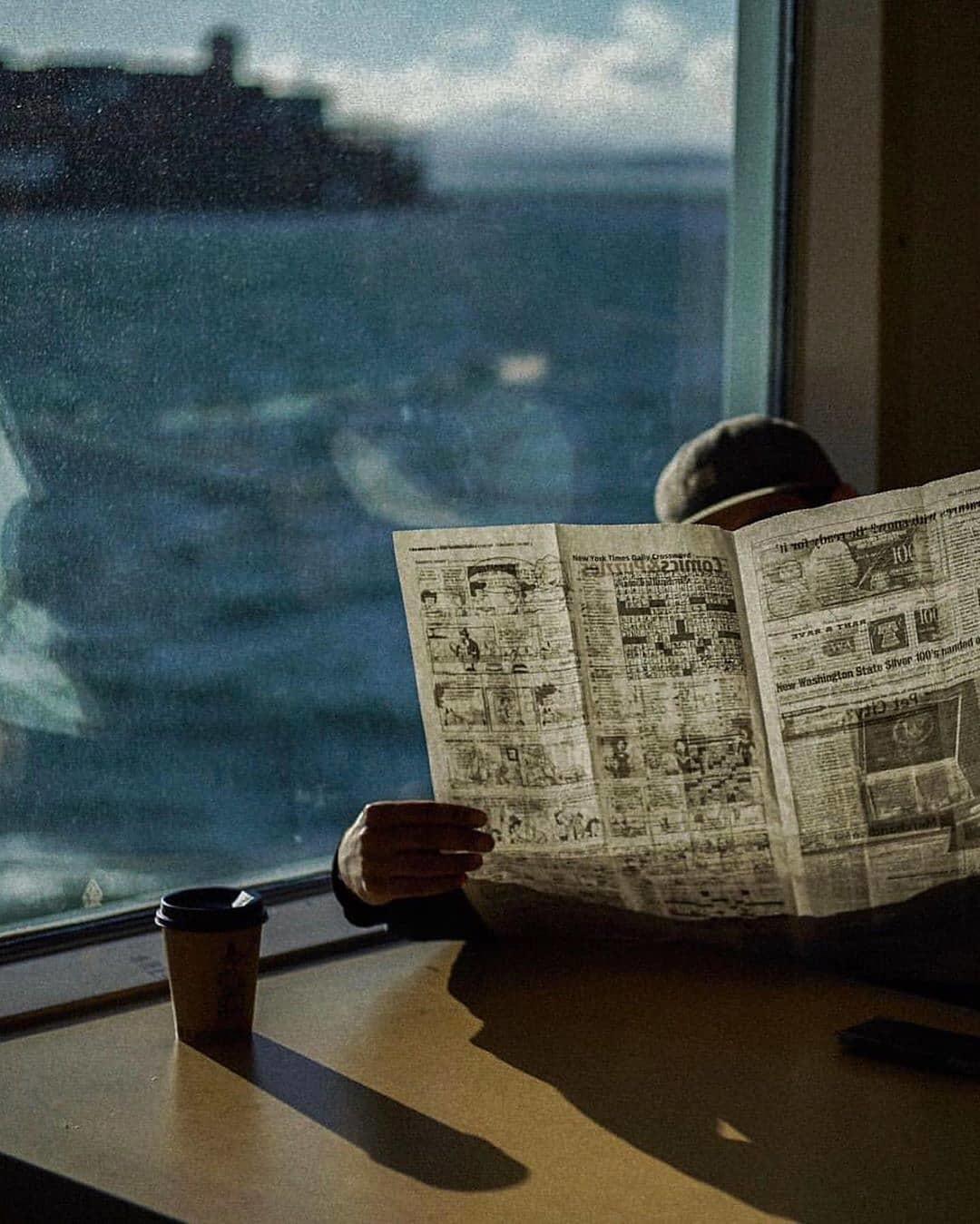  窗边看报纸的人，来自摄影师Anderson Wright。 