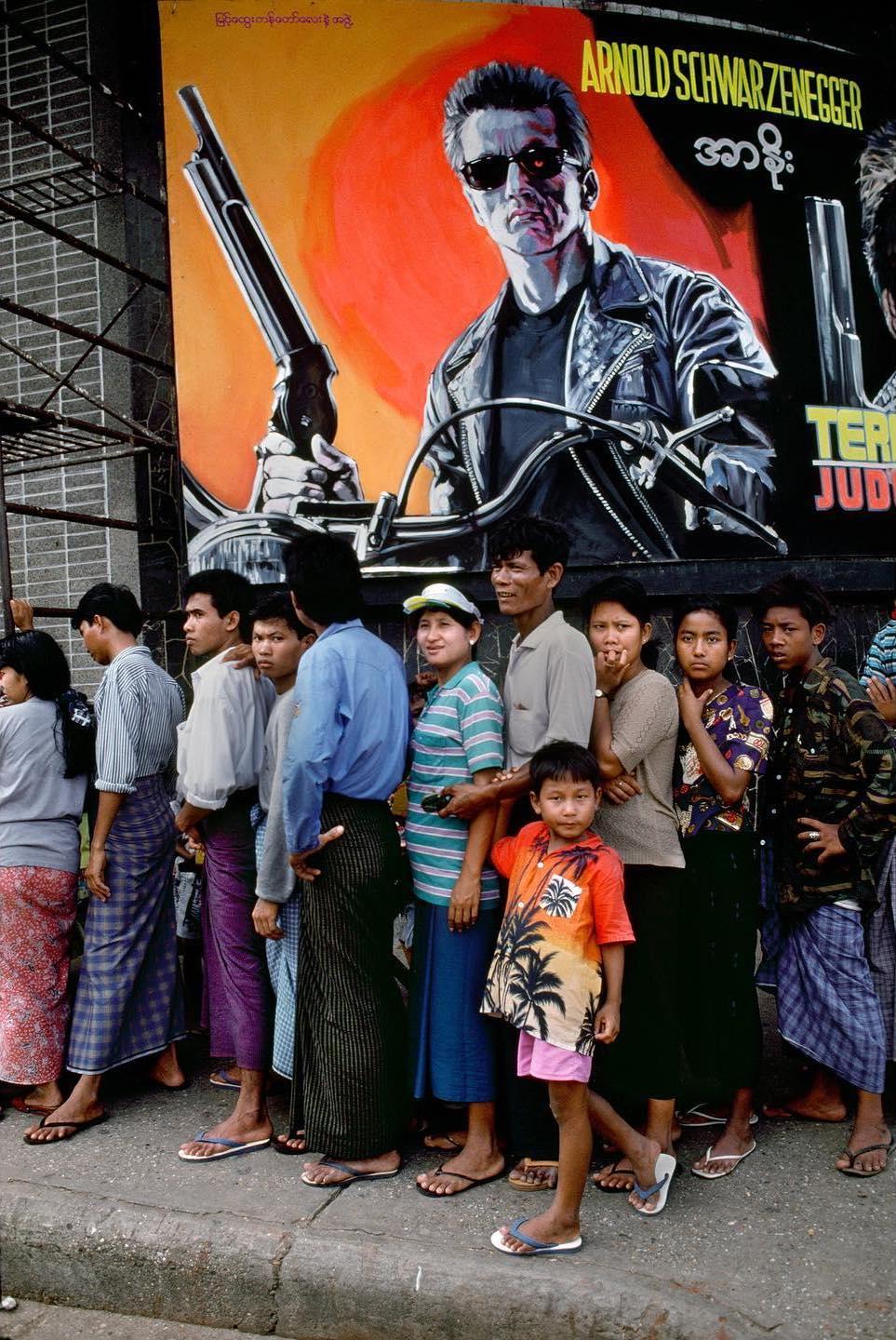  1994年缅甸街头排队的人和电影海报，来自摄影师Steve McCurry。 